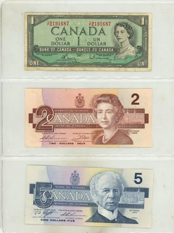 1954 Canada One Dollar and 1986 Canada Uncirculated Two and Five Dollars.