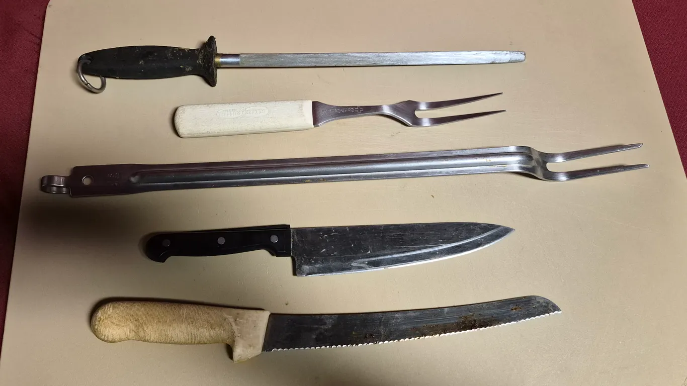 (2) Knives, (2) Pot Forks, (1) Sharpening Steel, (1) 18" x 26" Cutting Board