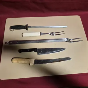(2) Knives, (2) Pot Forks, (1) Sharpening Steel, (1) 18" x 26" Cutting Board