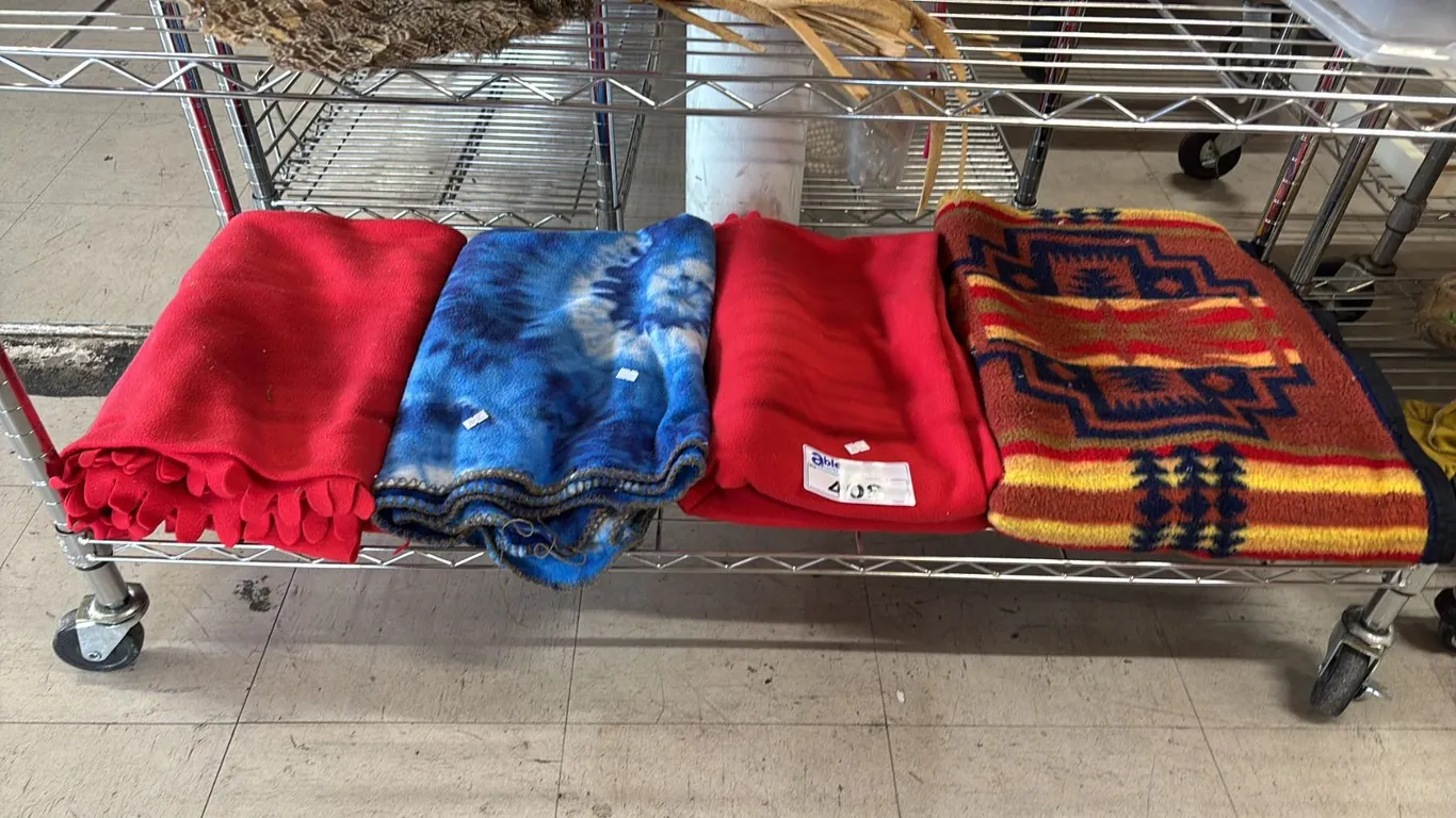 SHELF OF ASSORTED BLANKETS