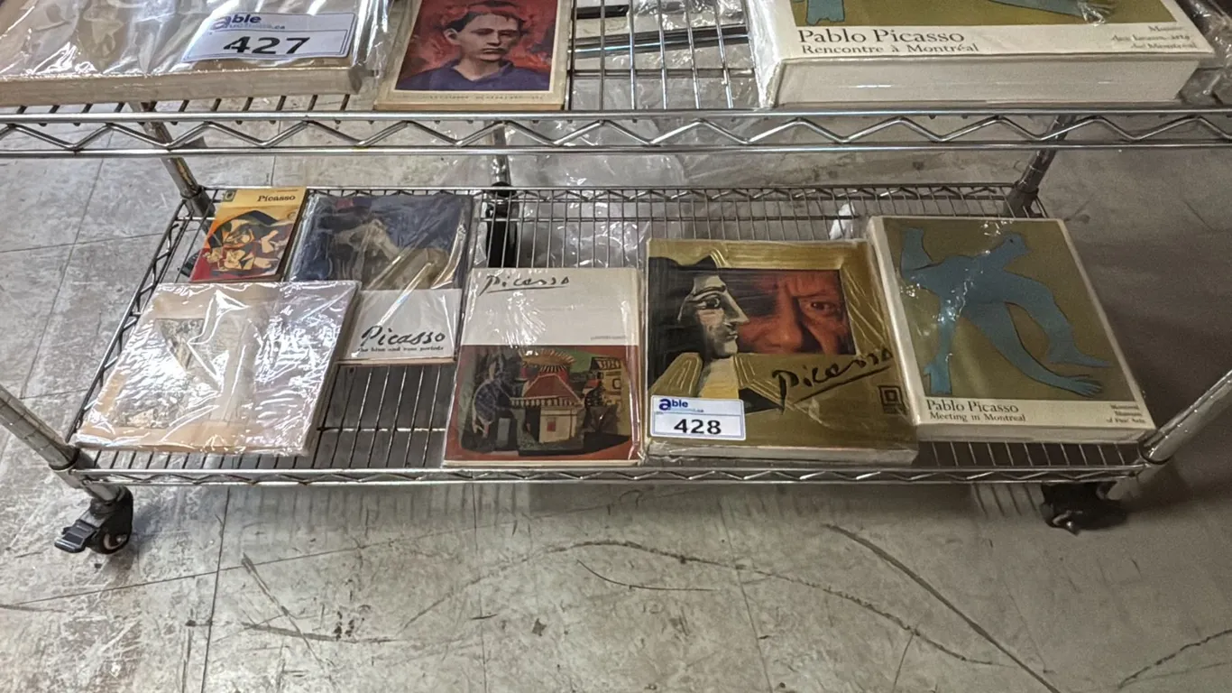 SHELF OF ASSORTED PABLO PICASSO BOOKS