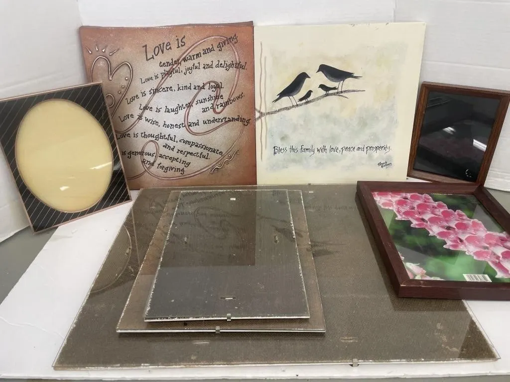 Two pieces of art and six picture frames.