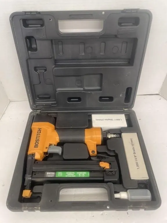 Bostitch air nailer with staples and a hard case.