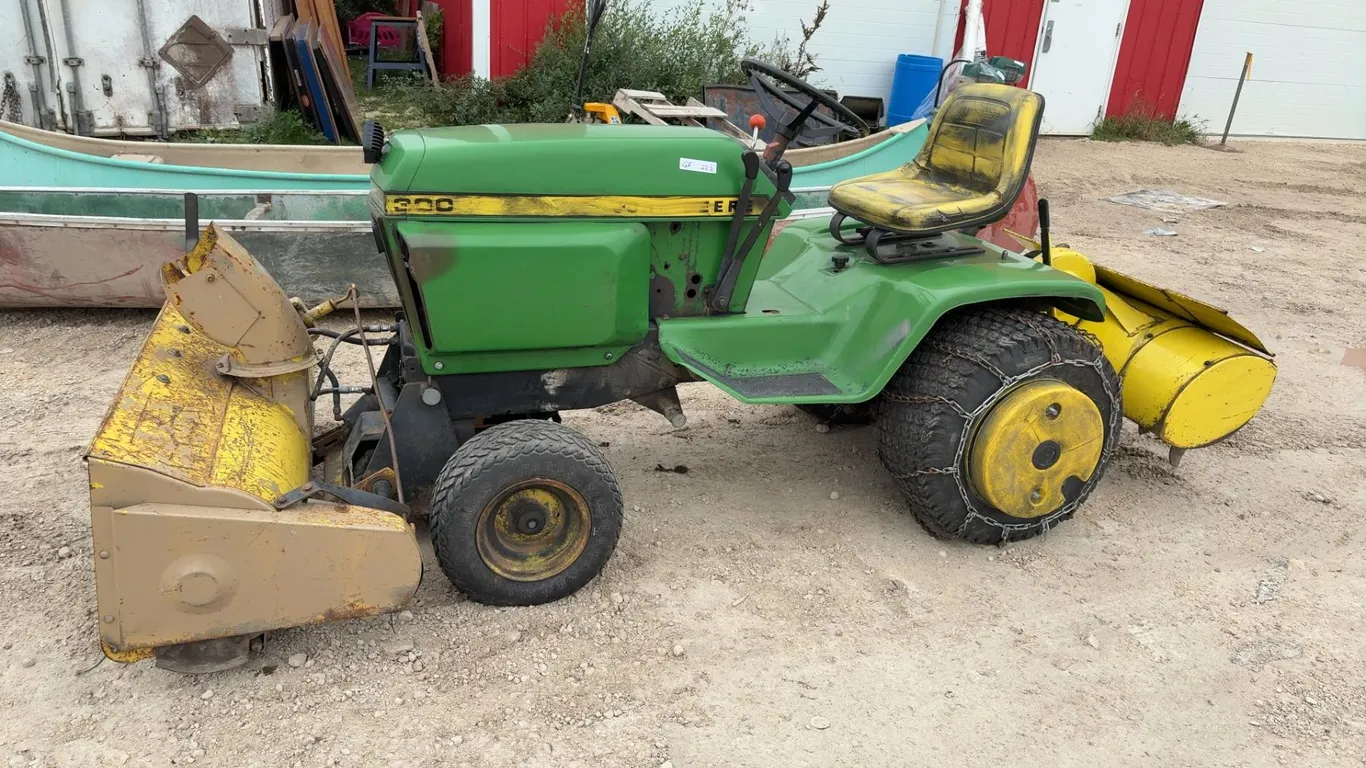 John Deere 300F Garden Tractor with Front Snow Blower, Rear Tiller, Tire Chains and Wheel Weights.