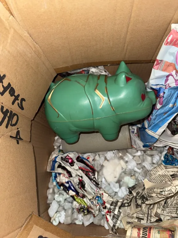 Two Decorative Piggy Banks Including Ceramic Pig with Red Overalls and Green Pig Bank