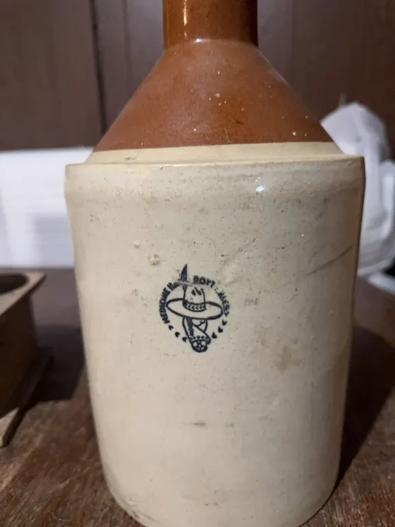 MedAlta Pottery jug made in Medicine Hat. Features a brown glazed upper section, sturdy handle, and