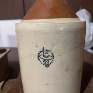 MedAlta Pottery jug made in Medicine Hat. Features a brown glazed upper section, sturdy handle, and 