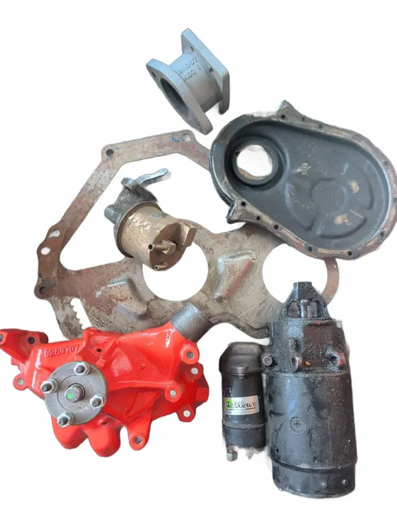 GM Engine Components Including Water Pump, Starter, and Timing Cover