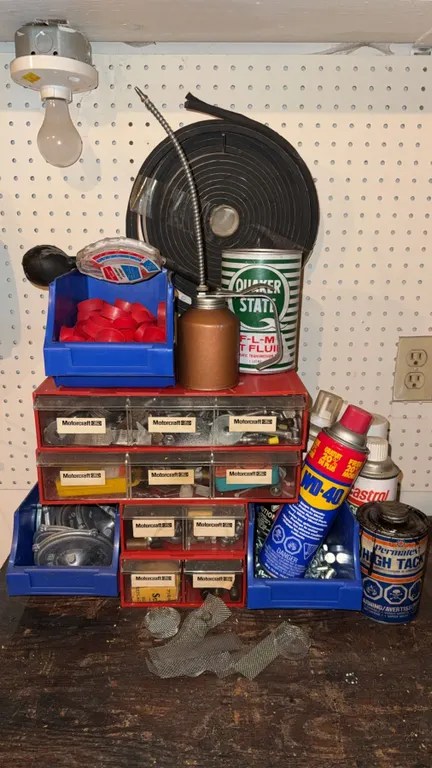 Workbench Lot With Oil Cans, WD-40, Parts Bins, and Assorted Hardware