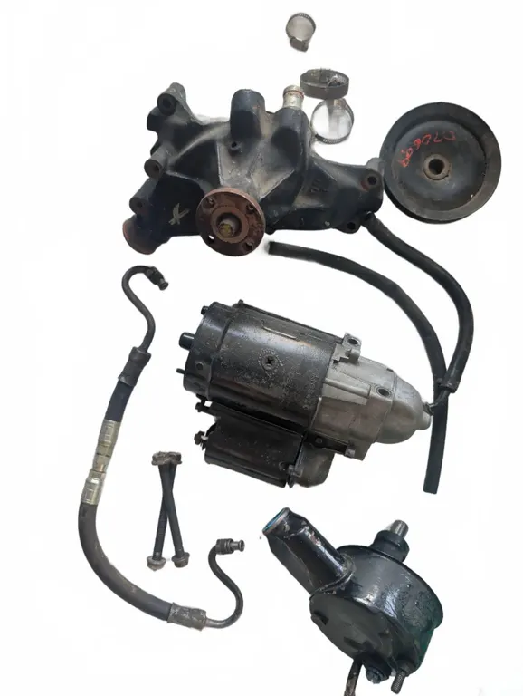 GM Engine Accessory Parts Lot With Starter, Water Pump, Pulley, and Hoses