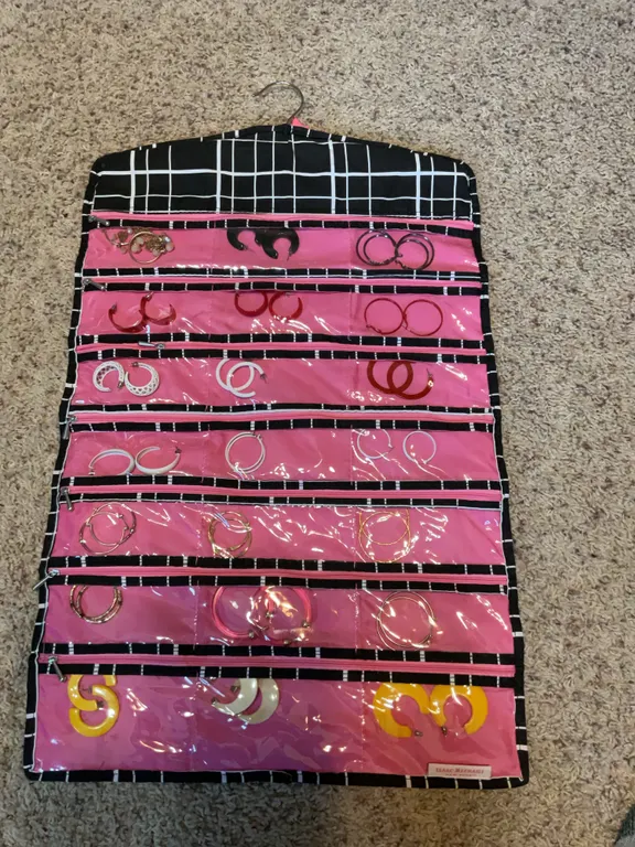 A double sided hanging jewelry case with earrings
