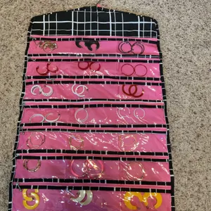A double sided hanging jewelry case with earrings