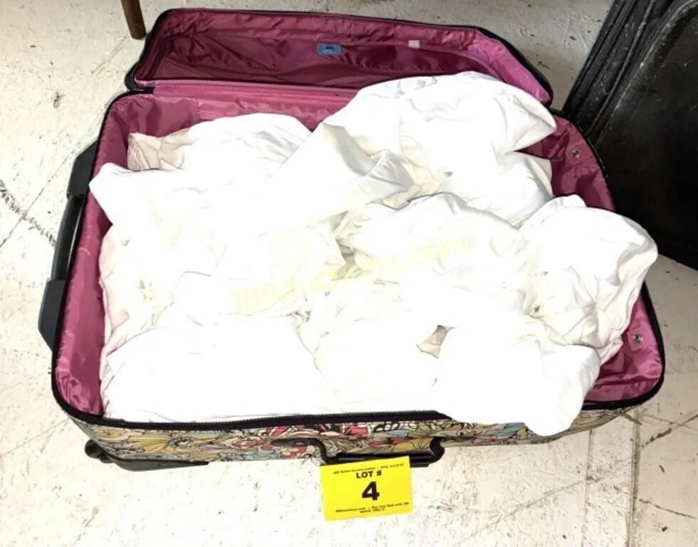SUITCASE FULL OF WHITE SHEETS