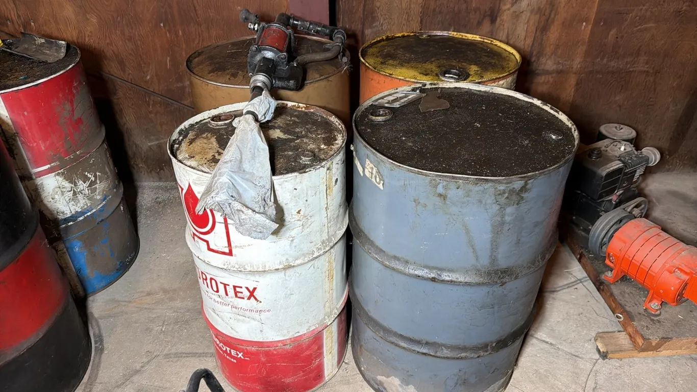 4) Empty 50 gallon barrels & barrel pump