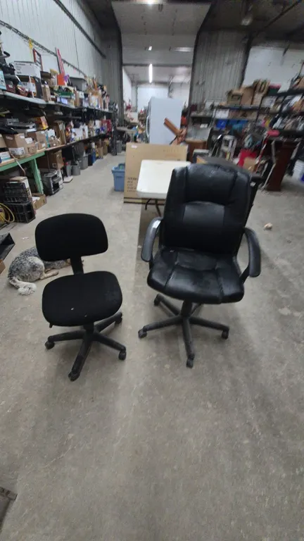 Two Black Office Chairs: One High-Back Executive Chair and One Low-Back Task Chair