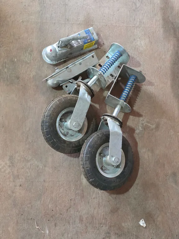 Trailer couplers and gate wheels