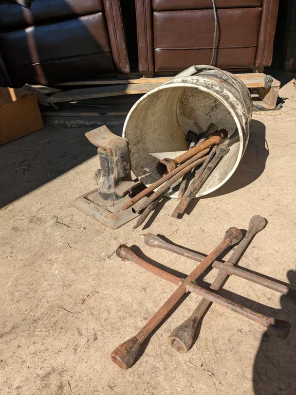 Bucket of spare wheel wrenches with jack