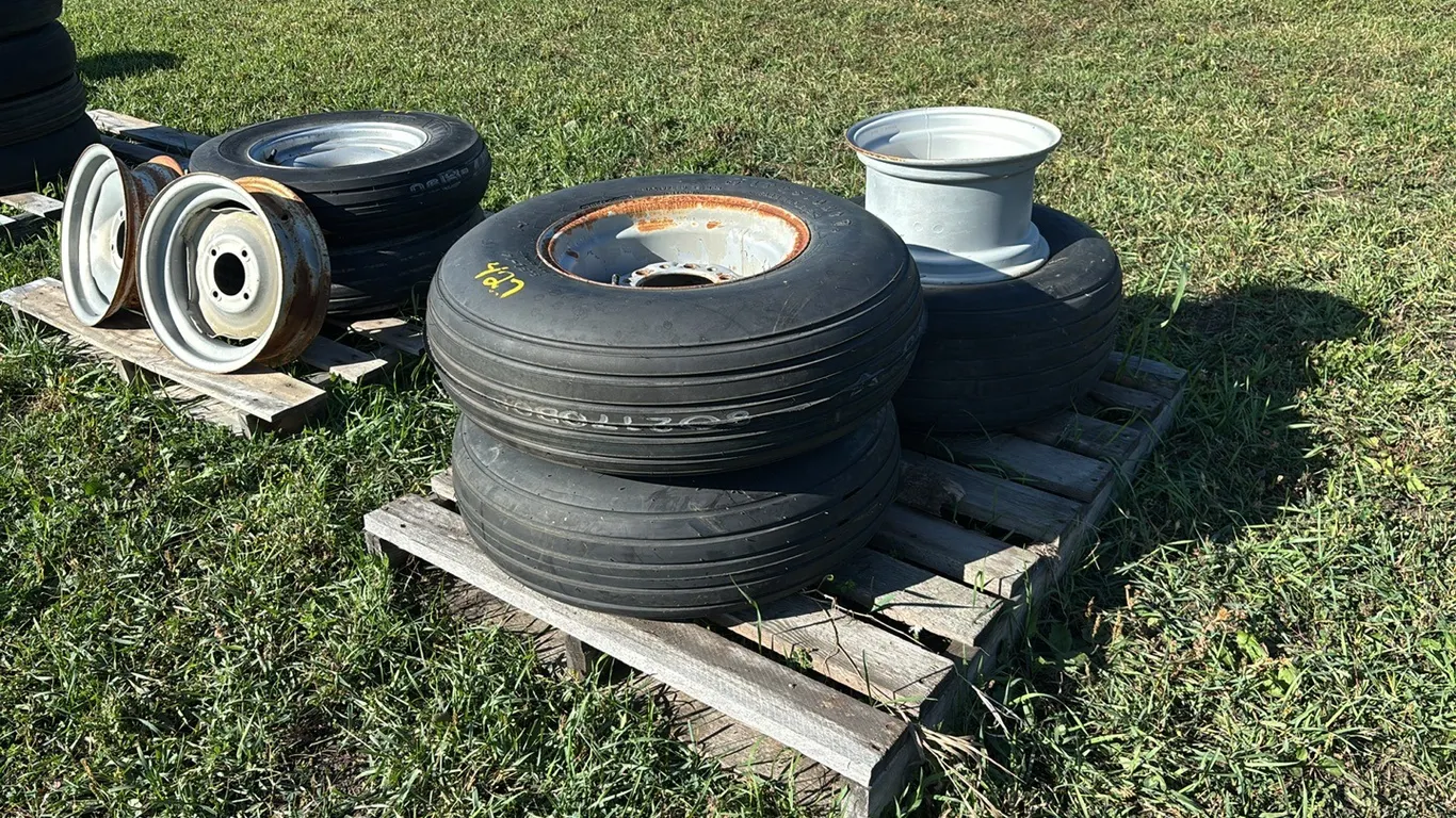 (2) Never Used 9.5L-14 6 Bolt Implement Rim Tires and (1) 11L-14SL Titan Tire on 6 Bolt Implement Rim and Spare 6 Bolt Implement Rim