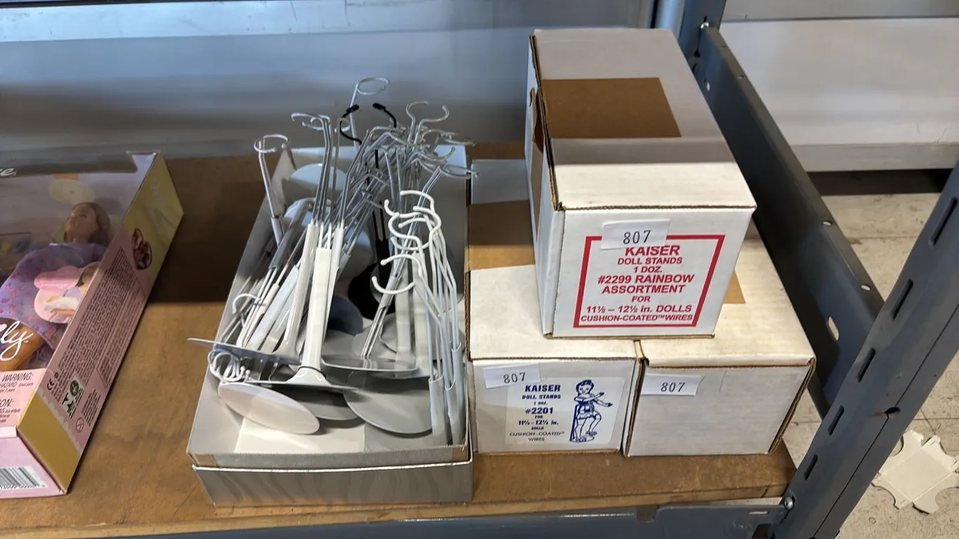 4 BOXES OF METAL DOLL STANDS