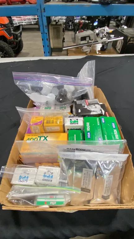 BOX OF ASSORTED FILM, FILM CANISTERS & DARK ROOM MATERIAL