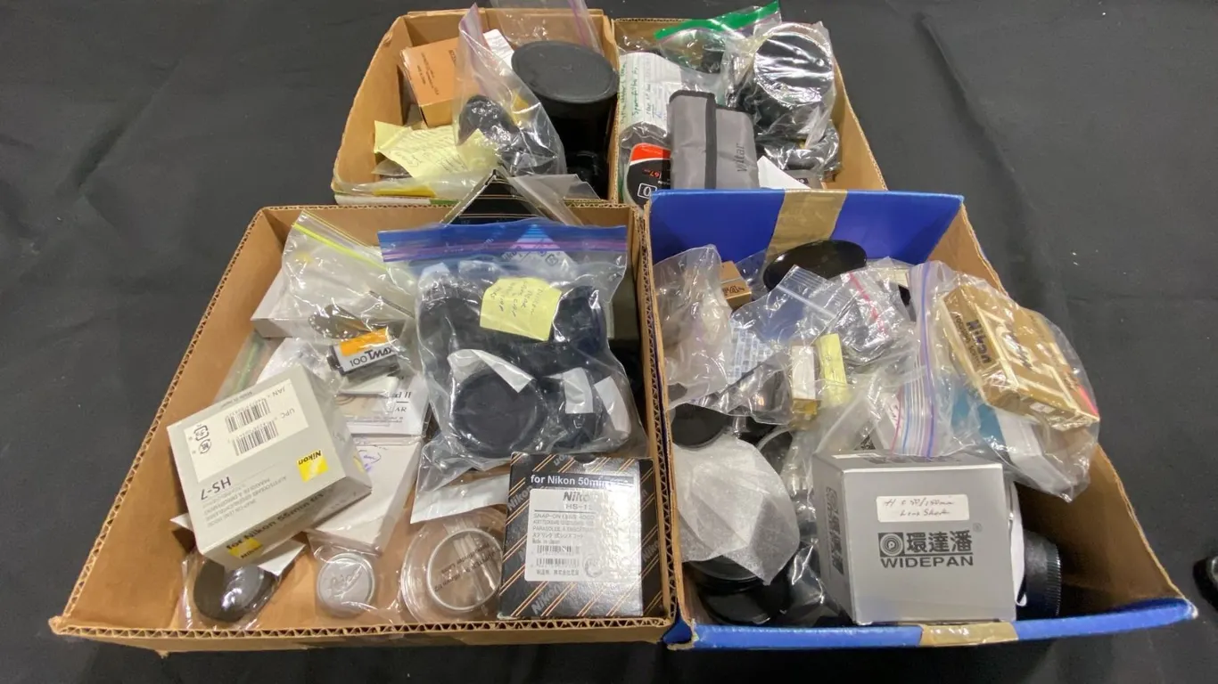 4 BOXES OF ASSORTED LENS SHADES/HOODS/CAPS, FOCUSING SCREENS & MORE
