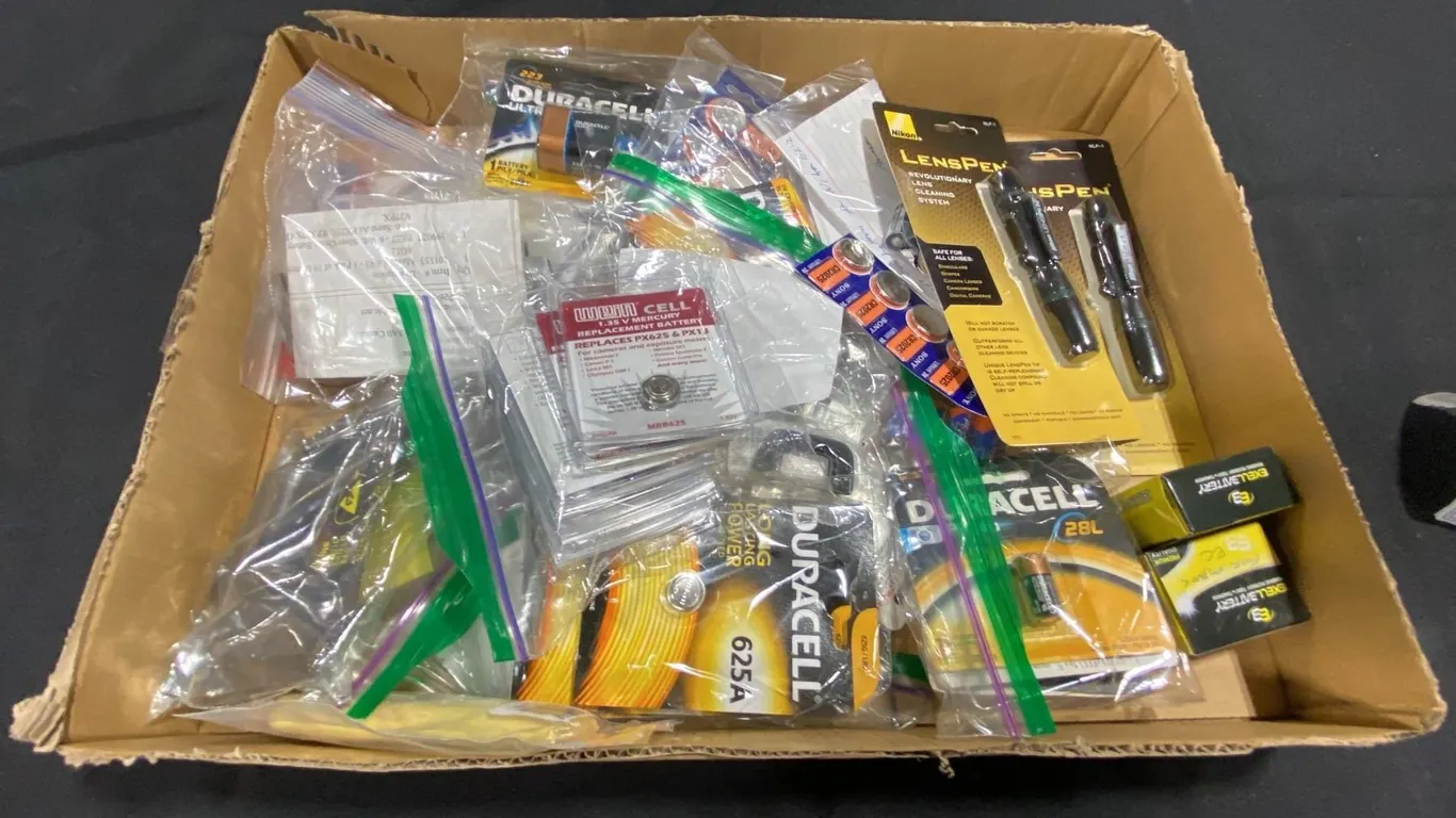 BOX OF ASSORTED CAMERA BATTERIES & LENS PENS