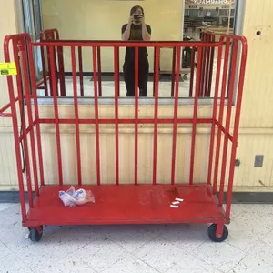 Kellogg's metal stock cart. Features red painted steel frame, 3-sided vertical bar enclosure, integrated side push handle, and retention strap. 5'L. M