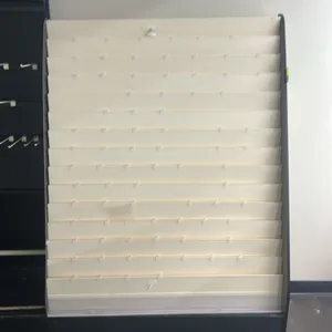 Laminate card and magazine merchandisers. Features multi-tier display pockets, wire racks, hanging hooks, overhead signage channels, and woodgrain lam