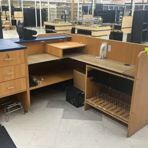 Laminate service counters. Includes (1) 12' x 3' counter run with black pegboard front, lower shelving, and drawers, and (1) 69" x 80" L-shaped servic