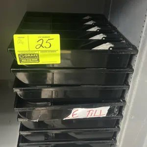 Cash drawer till trays. Features black plastic construction, spring-loaded bill clips, and integrated coin compartments. Storage cabinet and safe not 