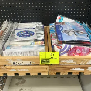 Wooden display crates with foil balloons. Includes an assortment of packaged foil party and novelty balloons featuring Betallic and Disney Frozen desi