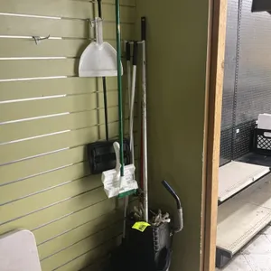 Poly mop bucket with wringer and cleaning supplies. Includes black plastic mop bucket with wringer on casters, mop, brooms, floor scrub brush, and dus