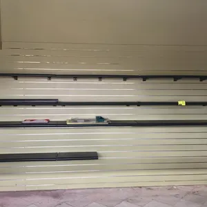 34'L of slatwall with 4'L poly shelves. Features horizontal slatwall panels with metal channel inserts and black poly shelves with mounting brackets. 