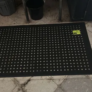 Poly floor mats. Includes one drainage hole floor mat and one ribbed floor mat. Features beveled borders and a black finish. Dimensions: 54" x 33" and