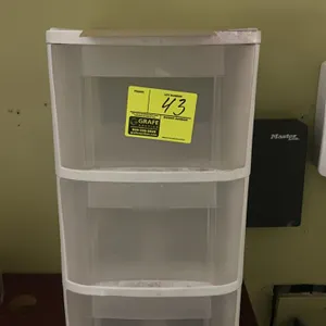 3-tier plastic drawer organizer. Features a white frame with three translucent pull-out storage drawers and integrated handles.