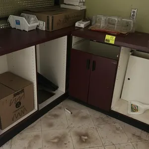 Laminate base counters. Features burgundy laminate finish, white interiors, open storage compartments, and hinged cabinet doors. 48" x 23" each. Note: