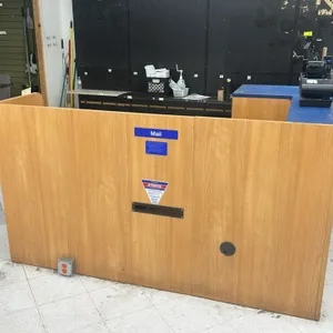 L-shaped laminate service counter. Features woodgrain laminate construction, raised blue transaction ledge, mail slot, 3-drawer locking pedestal, lowe