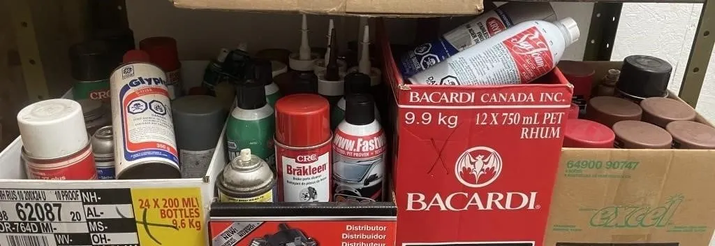 Four boxes of assorted cleaners, lubricants, and