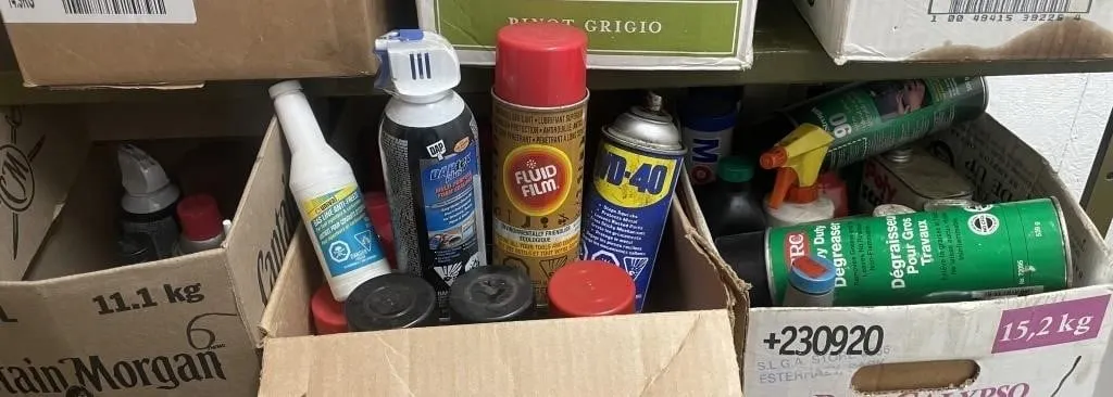 Three boxes of assorted cleaners, lubricants, and