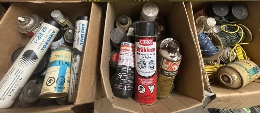 Three boxes of assorted cleaners, lubricants, and