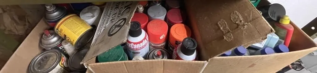 Three boxes of assorted cleaners, lubricants, and