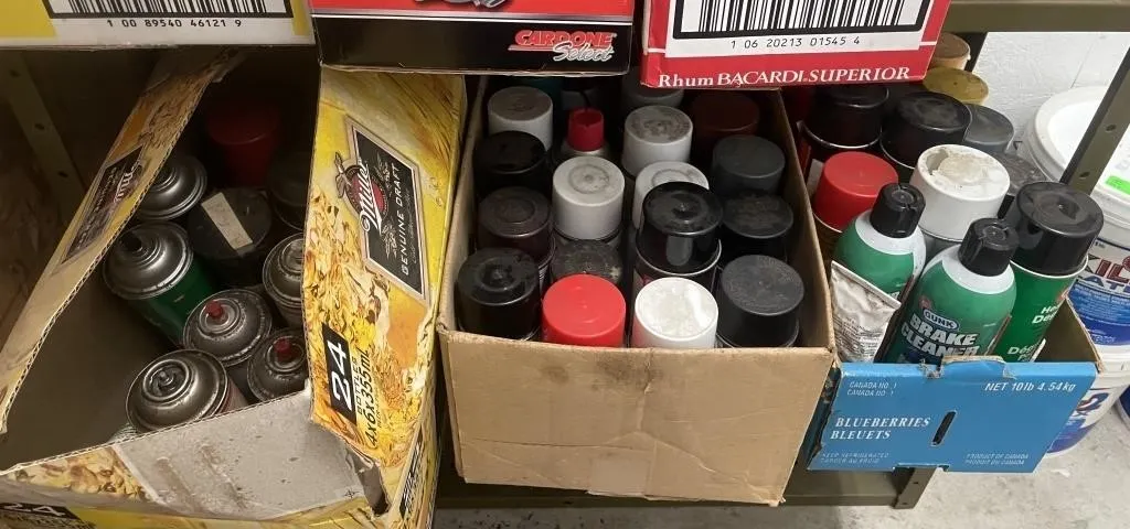Three boxes of assorted cleaners, lubricants, and
