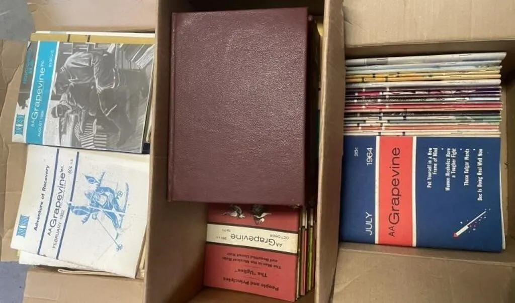 Three boxes of Alcoholics Anonymous Grapevine