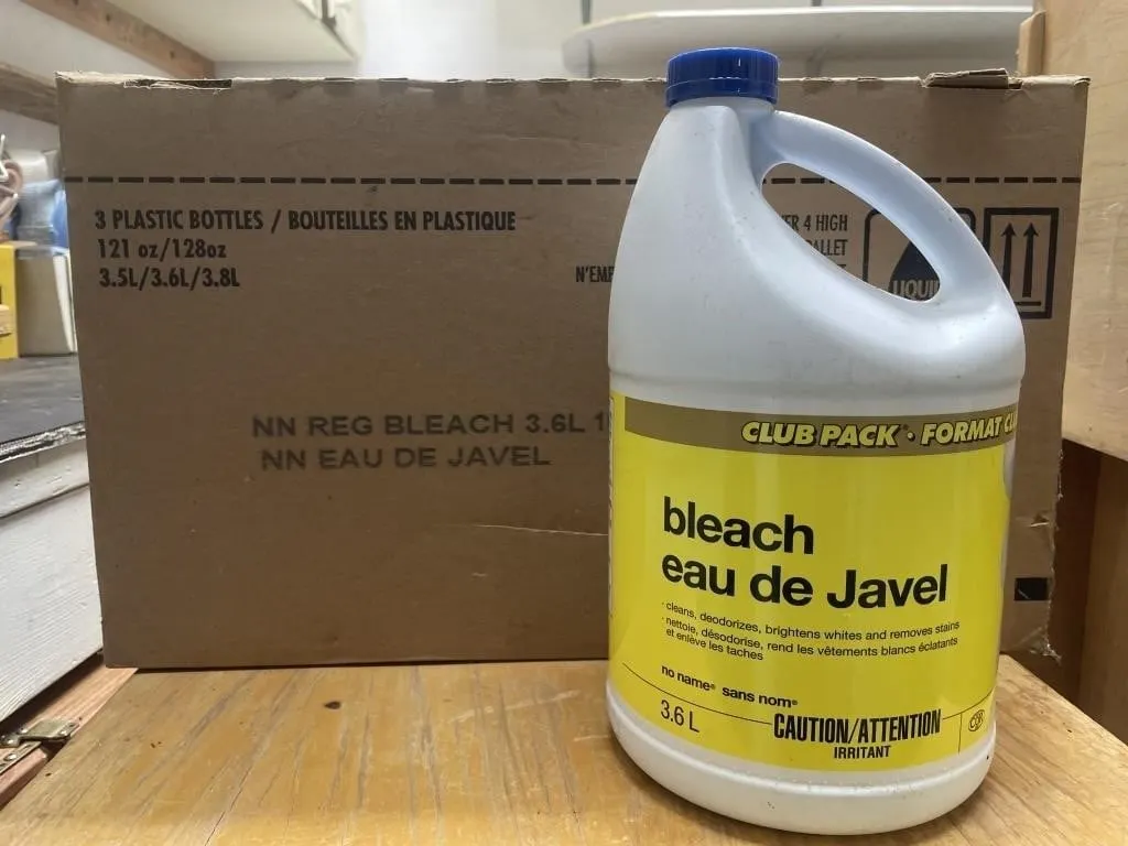 Three unopened bottles of bleach in a box.