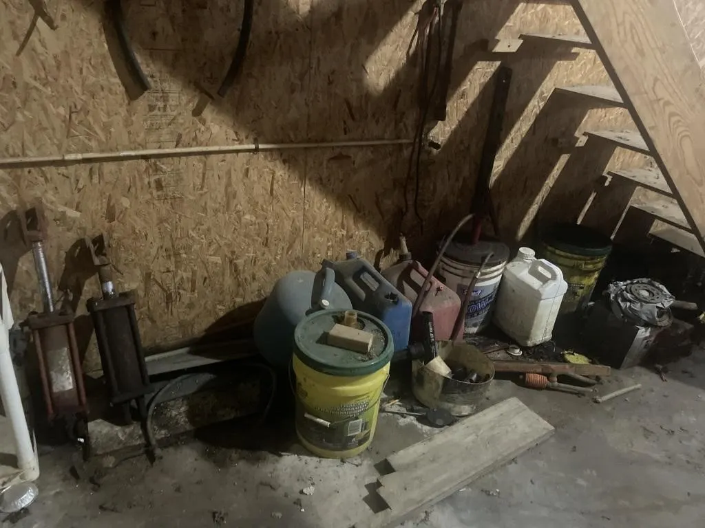 Contents under stairs - cylinders, gas cans,
