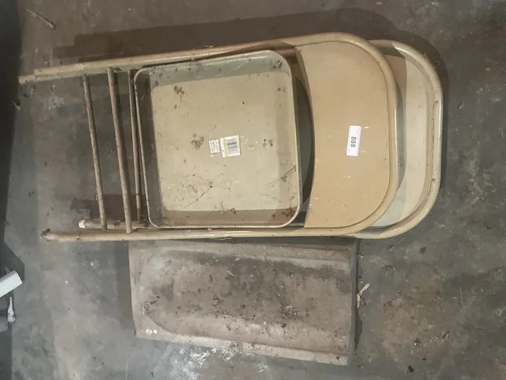 Two metal folding chairs, concrete gutter splash