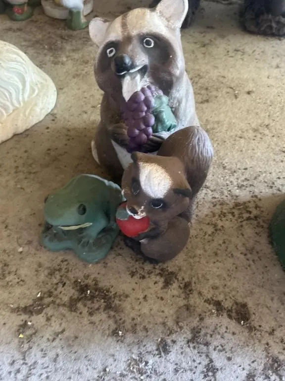 Concrete raccoon, squirrel, and frog