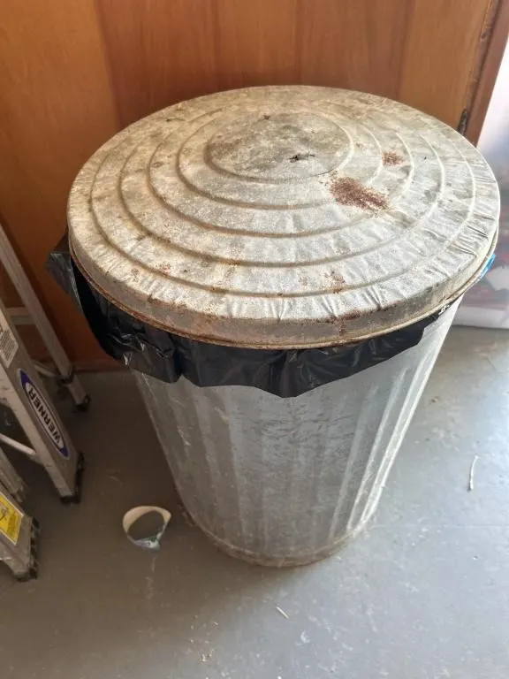 Metal trashcan with pop cans
