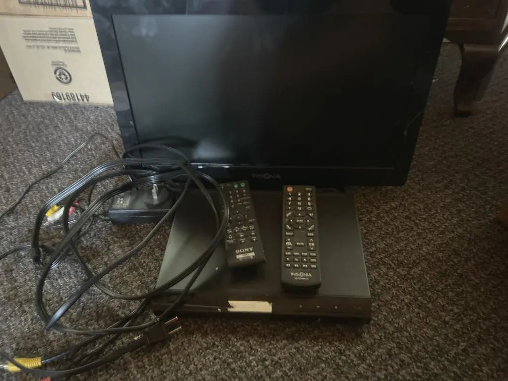 Insignia tv and Sony dvd player with cords and