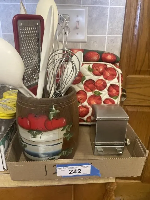 Wooden barrel with utensils, toaster with apple